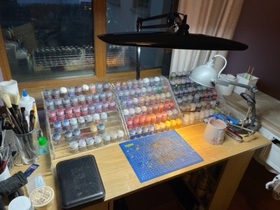 collection of paints on a painting table